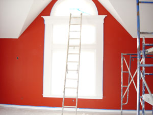 How to Paint New Woodwork - picture of construction site painting a window
